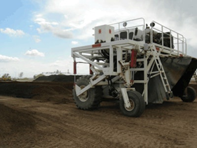 Scarab Composter aerating mixture of manure and sawdust.