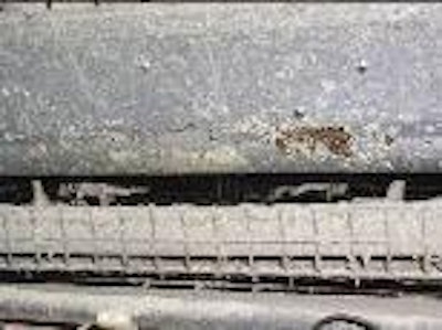 Corrosion damage from cooling pad droplets.