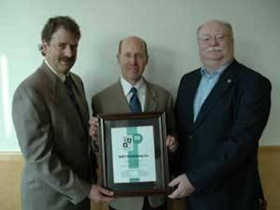 Greg Watt (center), president and CEO of WATT, receives a plaque recognizing WATT’s 35 years of exhibiting at the Midwest Poultry Federation Convention. Presenting the plaque on behalf of the Midwest Poultry Federation are Steven H. Olson, executive director, and Pete Rothfork, president.