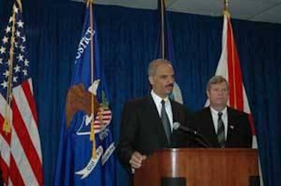As Secretary of Agriculture Tom Vilsack looks on, Attorney General Eric Holder talks about a new attitude of enforcement in antitrust matters in the Obama administration’s Justice Department.