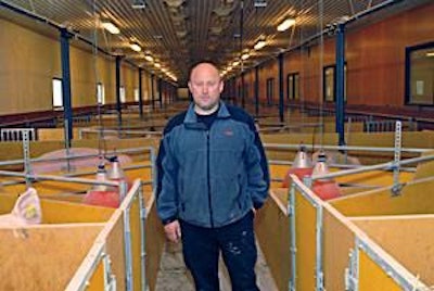 Swedish pig farmer, Johan Nilsson in one of his pig sheds with under floor heating harvested from slurry gutters.