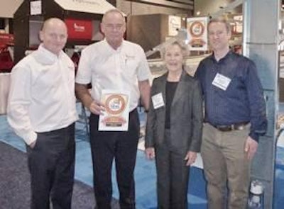Justin Potter and Mike Button of Potters Poultry International receive the seal of approval from Kathi Brook and Will Gillis of the American Humane Association.
