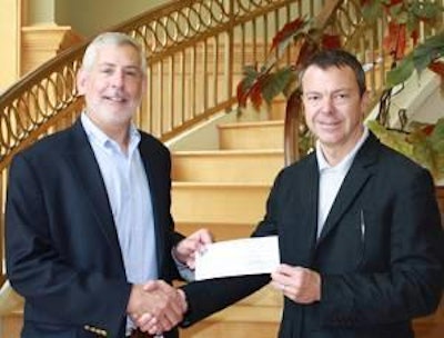 Dr. Don Connor, head of Auburn University’s Poultry Science Department, left, accepts the USPOULTRY Foundation student recruiting grant check presented by Mark Hickman, president and CEO of Peco Foods and USPOULTRY board member.