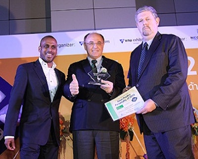 Erich Erber, center, accepts the Asian Personality Award from Ruwan Berculo, left, and Nigel Horrox.