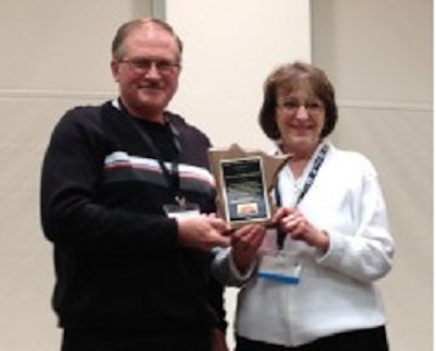 Doug and Linda Hedlund hold their Turkey Promoter of the Year award.