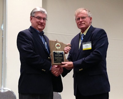 Grant Shold accepts the Ranelius Award from Minnesota Turkey Growers Association President Duane Jaenicke.
