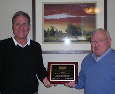 North Carolina Poultry Federation President Scott Prestage, left, and executive director Bob Ford hold the federation’s 2012 Grassroots Champion Award plaque, presented to them by the National Turkey Federation.