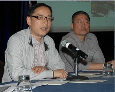 USAPEEC's Carl Shi, left, discusses avian influenza while participating in a panel discussion. Richard Hu, right, was also part of the panel.