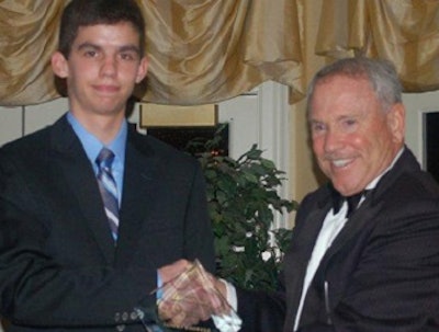 Josh Pressley, Junior Achievement student, North Hall High School, left, inducts Tommy Bagwell, chairman and CEO, American Proteins, into the Northeast Georgia Business Hall of Fame.