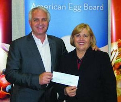 Jacques Klempf of Dixie Egg, chairman of the AEB with Joan Ivy, president of AEB, with a donation for relief following the earthquake in Haiti.