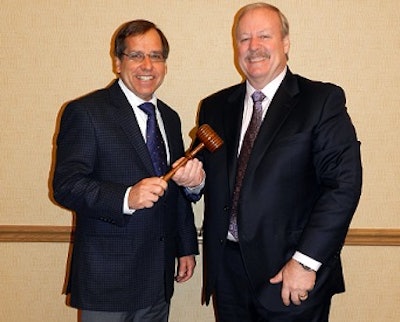 New American Egg Board chairman Paul Sauder, left, accepts the gavel from outgoing chairman Roger Deffner.