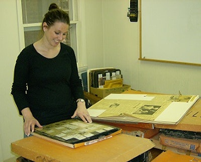 Leslie VanVeen McRoberts, access archives specialist at the Edward H. Nabb Research Center for Delmarva History and Culture at Salisbury University, looks at newspaper and magazine clippings being donated to the center by Delmarva Poultry Industry Inc.