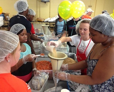Members of House of Raeford Farms' FLOCK team pack meals for Stop Hunger Now.
