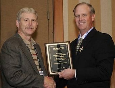 Mark Fales (left), sales manager for American CoolAir Corporation, accepts the long-time exhibitor plaque from Sherman Miller, Cal-Maine Foods, Jackson, Mississippi, and chairman of USPOULTRY.