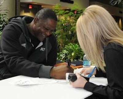 NBA Hall of Famer Dominique Wilkins signing an autograph at this year's International Production & Processing Expo.
