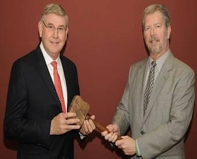 2014 chairman of U.S. Poultry & Egg Association, Elton Maddox (left) was presented with the traditional 'working man's gavel' by outgoing chairman, James Adams (right).