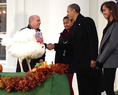 President Obama with daughters Malia and Sasha accept the National Thanksgiving Turkey from National Turkey Federation Chairman John Burkel of Badger, Minnesota. Joni Burkel and the couple's five children were also present.