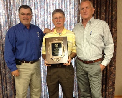 James Plyler receives The Poultry Federation’s Turkey Man of the Year Award from Gerald Duncan, left, agriculture operations advisor for Cargill Turkey and Cooked Meats, and Clint Grimsley, right, president of Valley of the Moon Commercial Poults.
