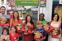 Employees from Tyson Foods and Sam’s Club gather with local families to kick off the “Be a Hunger Hero” campaign at the Sam’s Club in Fayetteville, Ark.
