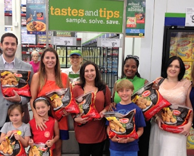 Employees from Tyson Foods and Sam’s Club gather with local families to kick off the “Be a Hunger Hero” campaign at the Sam’s Club in Fayetteville, Ark.