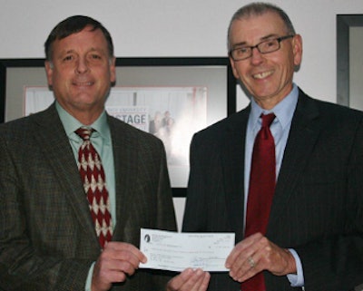 John Prestage, left, USPOULTRY board member, presents the 2013 foundation check forto Dr. Mike Williams, head of the NCSU Prestage Department of Poultry Science.