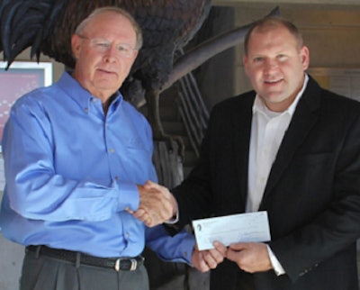 USPOULTRY board member Bill Bradley, left, presents Dr. Mike Kidd of the University of Arkansas with a USPOULTRY Foundation student recruitment grant.