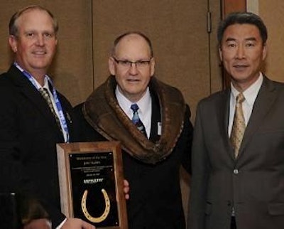 John Starkey, center, was named 2015 USPOULTRY Workhorse of the Year at the International Poultry Expo. He was “collared” with an actual horse collar by Dr. Hongwei Xin, right, 2014 Workhorse of the Year recipient. Starkey was presented with a commemorative plaque by newly elected USPOULTRY Chairman Sherman Miller.