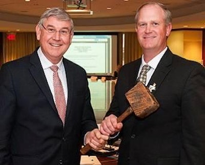 2015 chairman of U.S. Poultry & Egg Association, Sherman Miller, right, was presented with the traditional “working man’s gavel” by outgoing chairman, Elton Maddox.