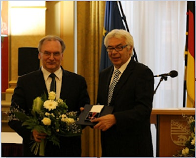 Gerhard Wagner, right, founder and CEO of Wimex, receives the Federal Order of Merit award.
