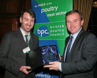 Nicholas Ham, left, receives the award for the Zoetis/British Poultry Council Trainee of the Year from Farming Minister George Eustice at the House of Commons.