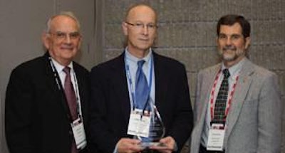 Dr. James Guy, professor at the College of Veterinary Medicine at North Carolina State University (center), holds the inaugural Dr. Charles Beard Research Excellence Award.