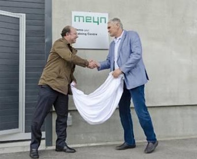 Scott Russell, Meyn global sales director, and Willem Wals, owner of the premises where the center is located, unveiled the name plate for the demonstration and training center.