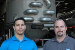 Eric Lindemann and Alex Sullivan with one of three UMDK decanting units in the background.