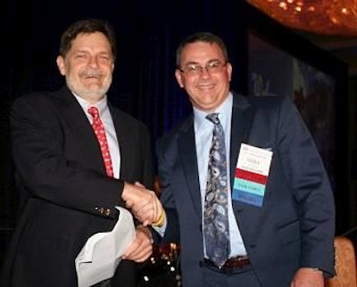 Jim Wayt, left, Intervision Foods, assumes the position of chairman of USAPEEC for 2015-16 from outgoing chairman Mike Little, Mountaire Farms.