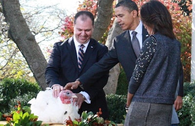 Yubert Envia, 2010 chairman of the National Turkey Federation, presents Apple, the 2010 National Thanksgiving Turkey, to the Obama family. | Foster Farms