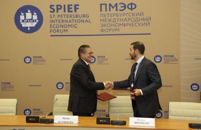 Cherkizovo CEO Sergei Mikhailov shakes hands with Russian Minister of Economic Development Alexey Ulyukaev at the St. Petersburg International Economic Forum. | Cherkizovo