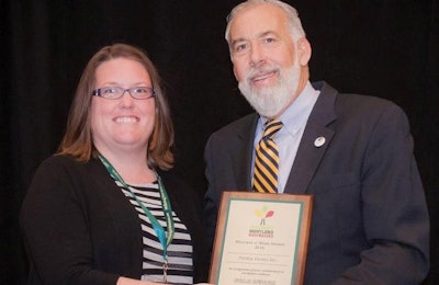 Cheryl Stafford, corporate health strategies manager at Perdue Farms, accepts the Gold Wellness at Work Award from Van Mitchell, secretary of the Maryland Department of Health and Mental Hygiene. | Perdue Farms