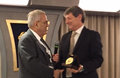Dr. Nuhad Daghir, president of the Mediterranean Poultry Network, left, and Mr. Ghassan Sayegh, Mediterranean Poultry Summit organizer, right, take part in the summit's closing ceremony.