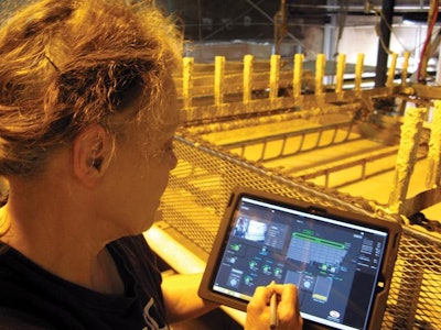 The operator uses a stylus and digital pad to remotely the control operation of the wastewater treatment system.