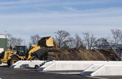 Raw material for Perdue's AgriSoil compost process is loaded into concrete bunkers and covered by a high-tech fabric that seals in odors and speeds up the natural composting process. | Perdue Farms