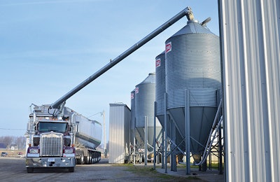 Remote-controlled booms increase biosecurity by allowing the truck operator to unload feed while inside the cab. | Walinga Inc.