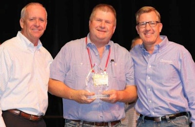 James Smith, center, was presented with The Poultry Federation's 2017 Industry Leader of the Year award by TPF President Marvin Childers, left, and Simmons Foods CEO Todd Simmons. | The Poultry Federation