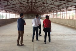 The new open-sided houses are single span with concrete floors, making cleaning and disinfection easier. | Mark Clements