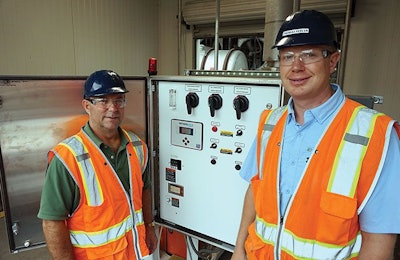 Regional Environmental Manager Kevin Milner and Complex Environmental Manager Thomas Percer at the upgraded stormwater lift station pump controls located near the cooling sheds. | Image courtesy of Pilgrim's Pride Corp.