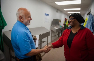 John Tyson, chairman of the Tyson Foods Board of Directors, greets Debra Winfrey, team member at the Tyson plant in North Little Rock, Arkansas, as the company observes the plant's 50th year in operation. | Photo courtesy of Tyson Foods