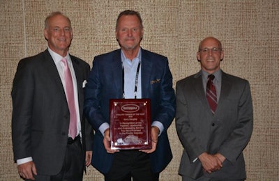 Butterball CEO Kerry Doughty, center, is presented with the Urner Barry 2018 Poultry Person of the Year award by Mike O'Shaughnessy, left, and Russ Whitman. | Photo courtesy of Butterball
