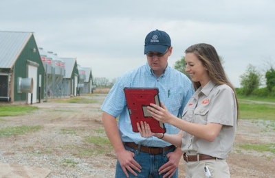 Angela Patton, a Tyson Foods Inc. service technician, works with Austin Butler, a contract chicken farmer. Photo courtesy of Tyson Foods Inc.