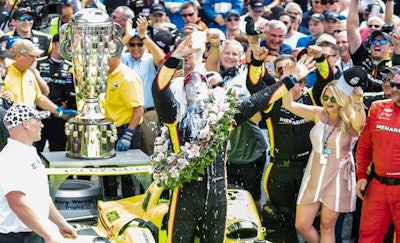 Simon Pagenaud celebrates his first Indianapolis 500 win with the traditional glass of milk after the race. (actionsports | BigStock.com)