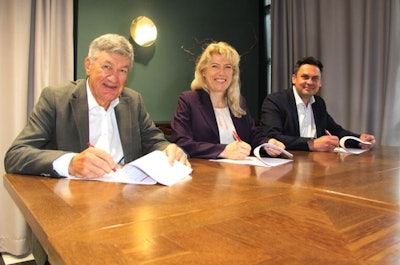 Hannu Alanko and Asa Alanko of Atria sign documents with Mika Ala-Fossi Domretor Oy as Atria completes its acquisition of Domretor. (Atria)