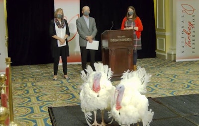 Cob and Corn, the 2020 presidential turkeys, were introduced in the nation's capital on November 23. Pictured in the background are the farmers who raised the turkeys, Susie and Ron Kardel, and Beth Breeding, National Turkey Federation vice president of communications and marketing. (Screenshot from YouTube)